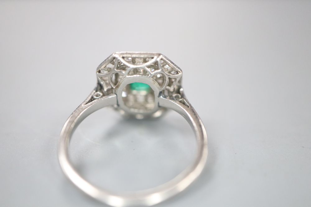 An Art Deco white metal, emerald and diamond set octagonal tablet ring, (emerald chipped), size J/K, gross 3.4 grams.